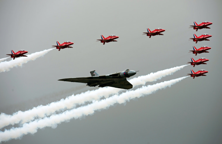 Image: The Red Arrows fly in formation alongsid